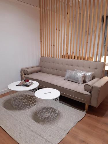 a living room with a couch and two tables at Alma s HOME, precioso loft en planta primera in Bollullos par del Condado