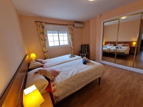 a bedroom with a large bed and a large mirror at VELEZ NAZARI CENTRO 2 in Vélez de Benaudalla