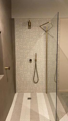 a shower with a glass door in a bathroom at Relais Chiarene in Novello