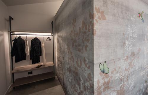 a walk in closet with a gray wall at Relais Chiarene in Novello