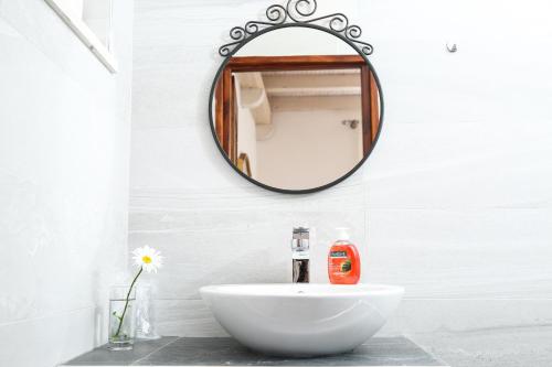 a bathroom with a white sink and a mirror at Spacious apartment Lucia in Prožura