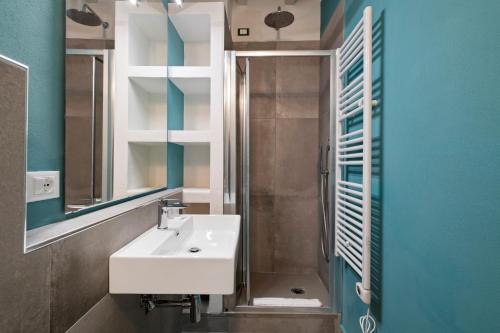 a bathroom with a sink and a shower and a mirror at La Loggia della Signoria Charming Loft in Florence