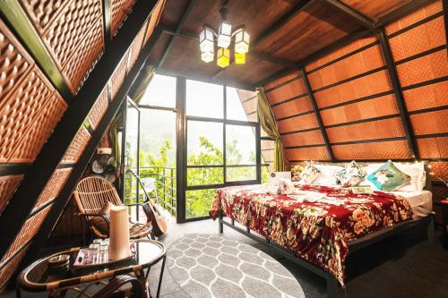 a bedroom with a bed in a room with a window at Holistic Stay Eco-Resort & Ayurvedic Retreat in Paithalmala