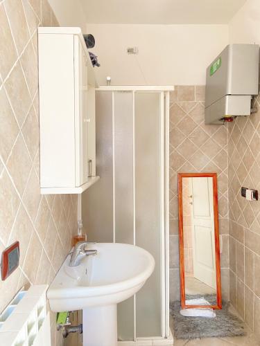 a bathroom with a sink and a mirror at Suite Angeli, a due passi da Assisi in Santa Maria degli Angeli