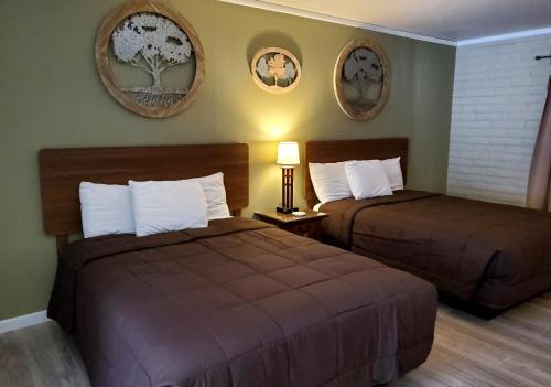 a hotel room with two beds and two mirrors at Roosevelt Resort Park in Grapevine