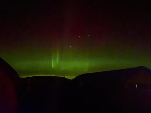 an image of the northern lights in the sky at 3 Sinclair Bay Lodges in Keiss
