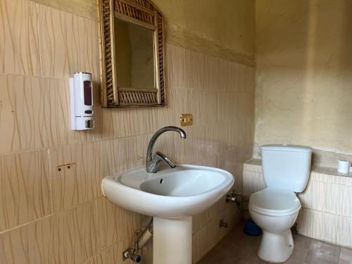 a bathroom with a sink and a toilet at Zad El Mosafer Guest House in Tunis