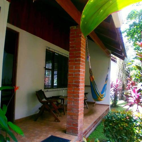 a porch of a house with a hammock at Escape Caribeño in Puerto Viejo