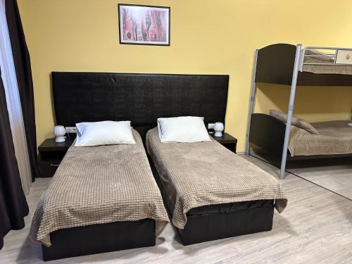 un dormitorio con dos camas y una litera en Apartments & Rooms Royal Plaza, en Borovets