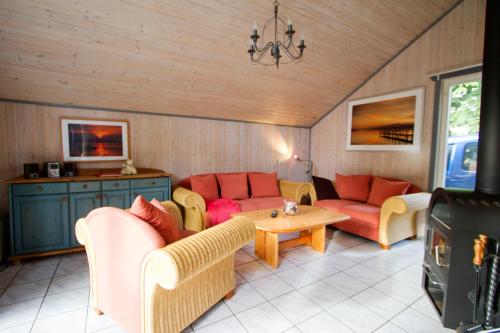 a living room with two couches and a table at Ferienhaus Mirow 66 in Mirow