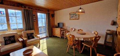a dining room with a table and chairs at Edelweiss 6 in Champoussin