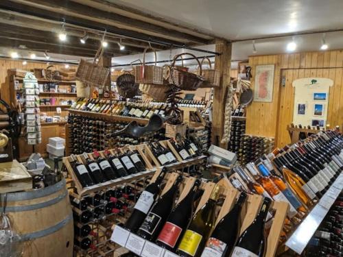 un negozio pieno di bottiglie di vino di Escape to a Cosy Country Barn: Discover the Charm of Rustic Living 