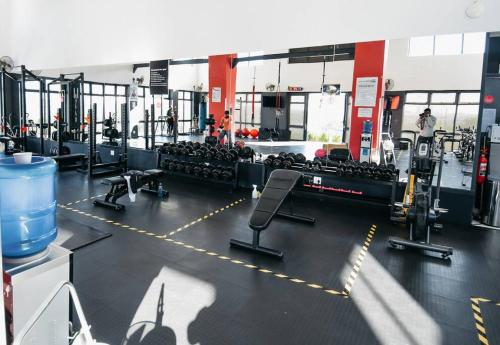 a gym with several treadmills and machines at Secure and comfortable , Fully equipped Unit in Lombardy East