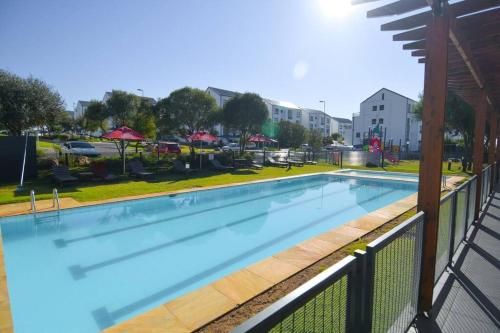 a large swimming pool on a balcony of a building at Secure and comfortable , Fully equipped Unit in Lombardy East