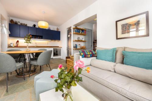 a living room with a couch and a table at Bralos Villa - Paros, Sea View in Kóstos