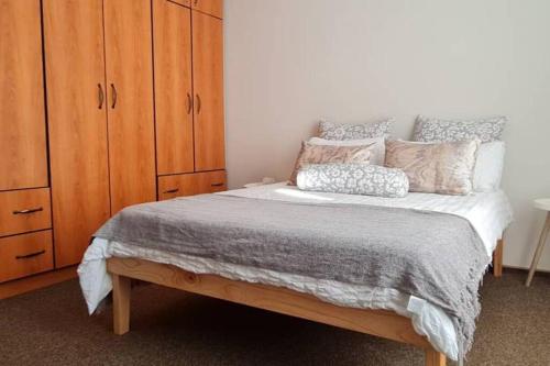 a bedroom with a bed and a wooden cabinet at Swakopmund holiday Apartment in Swakopmund