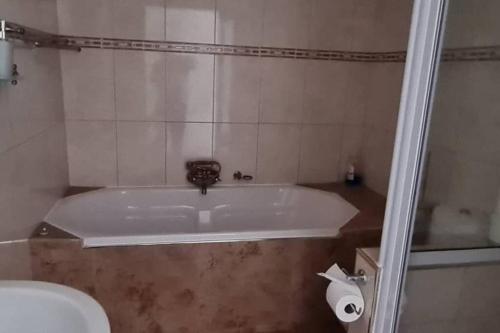 a bathroom with a bath tub and a toilet at Swakopmund holiday Apartment in Swakopmund