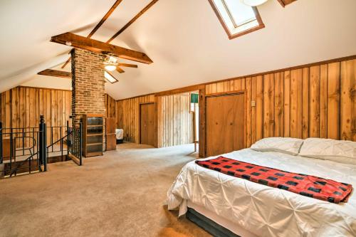 a bedroom with a bed in a room with wooden walls at Cozy Wilcox Home on East Branch of Clarion River! in Wilcox