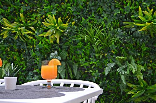 a glass of orange juice sitting on a table at Lisbon City Hollywood Hotel by City Hotels in Lisbon