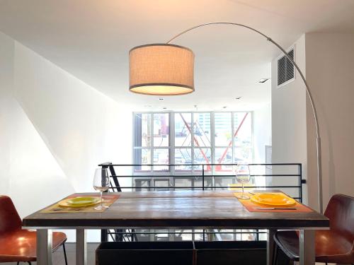 a dining room with a table and a lamp at Duplex Suite in Art Tower in Philadelphia