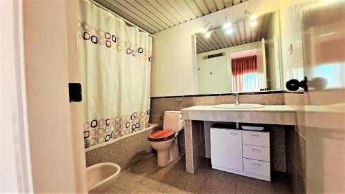 a bathroom with a sink and a toilet and a mirror at Apartamentos Riviera Niza 05 in Salou