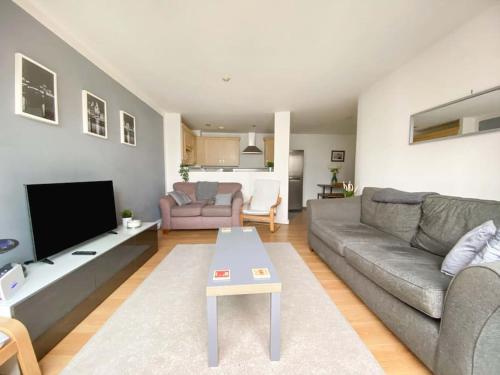 a living room with a couch and a table at Liverpool One Beautifully Presented 2 Bedroom Apartment in Liverpool