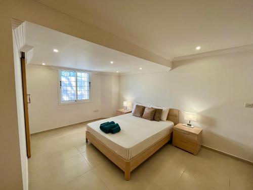 a bedroom with a bed and two lamps and a window at Dream Beachfront Bungalow in Limassol