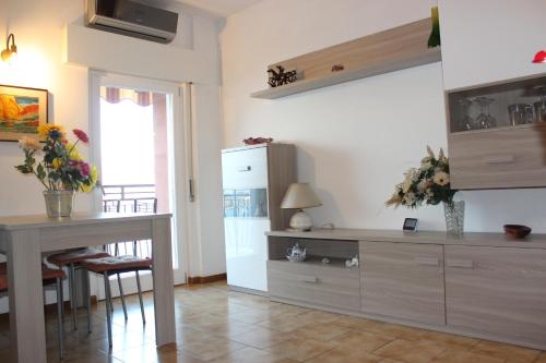 a kitchen with a table and a refrigerator at Bellavista garden and flowers in Varenna
