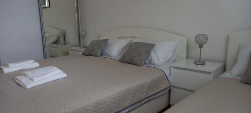 a bedroom with a bed with towels on it at Marys Home Apartment Međugorje in Međugorje