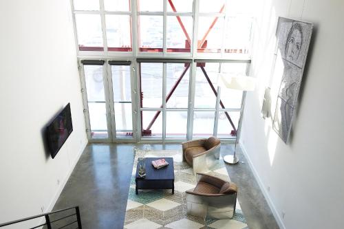 a living room with couches and a large window at Duplex Suite in Art Tower in Philadelphia