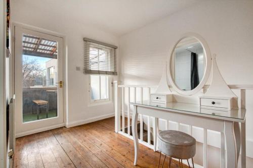 a dressing room with a mirror and a stool at Shoreditch Balcony 2 BDR Apartment in London