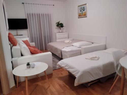 a living room with two beds and a couch at Marys Home Apartment Međugorje in Međugorje