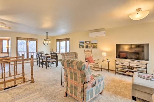 a living room with a couch and chairs and a television at Rapid City Vacation Home with Wraparound Deck! in Rapid City