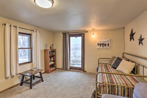a living room with a bed and a window at Rapid City Vacation Home with Wraparound Deck! in Rapid City