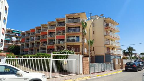 a tall building with cars parked in front of it at BELLAMAR 25 in Cambrils