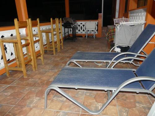 a group of chairs and tables on a patio at Southern Haven Guesthouse in Laborie