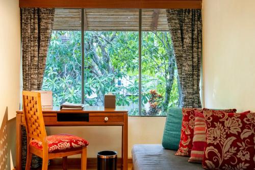 a desk and a chair in a room with a window at Centara Koh Chang Tropicana Resort in Ko Chang