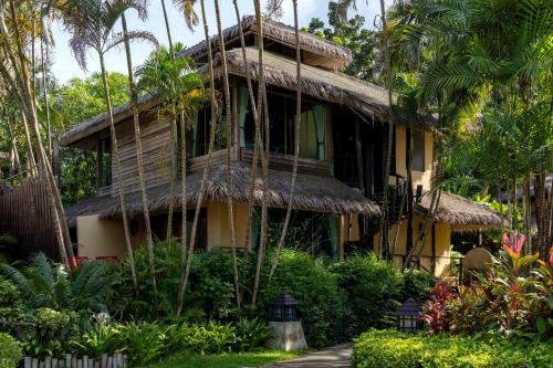a resort building with a thatch roof at Centara Koh Chang Tropicana Resort in Ko Chang