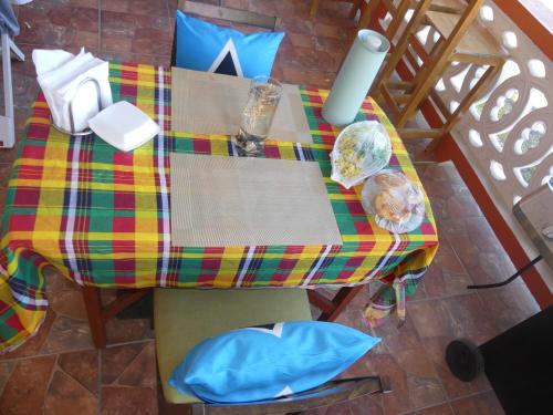 a table with a colorful table cloth on it at Southern Haven Guesthouse in Laborie
