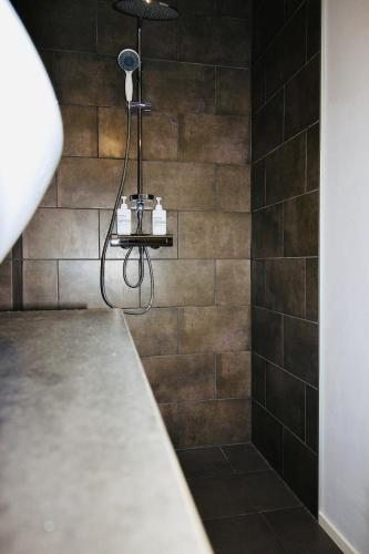 a bathroom with a shower with a black tiled wall at Stylish house in the heart of Lapland in Tornio in Tornio
