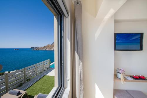a room with a view of the ocean at Sene Villa - Sea Front in Plakias