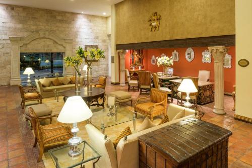a living room with couches and a fireplace at Quinta Real Saltillo in Saltillo