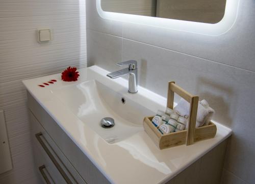 a bathroom sink with a soap dispenser on it at Sene Villa - Sea Front in Plakias