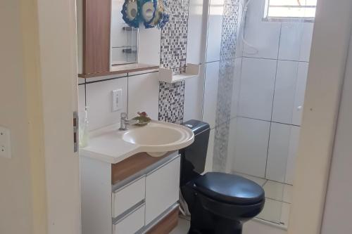 a small bathroom with a sink and a toilet at Repouso da Cachoeira in Foz do Iguaçu