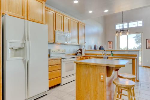 a kitchen with a white refrigerator and wooden cabinets at Cinnamon Teal Dream in Redmond