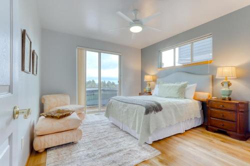 a bedroom with a bed and a chair and a window at Cinnamon Teal Dream in Redmond