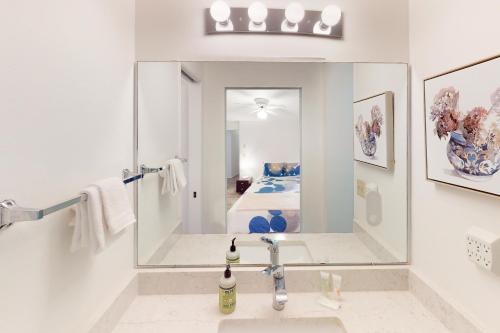 a white bathroom with a sink and a mirror at Gilham Gem in Eugene