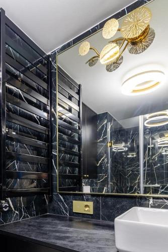 a bathroom with a sink and a mirror at Amber Stone Apartment 2nd floor in Palanga