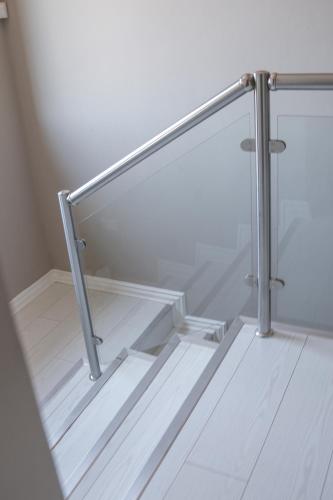 a set of glass stairs with a metal railing at Modern Home in Pretoria near Menlyn Mall in Pretoria