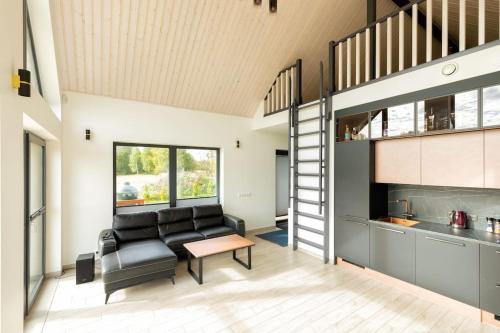 a living room with a couch and a table at Tartu Pajuoja saunamaja in Tartu